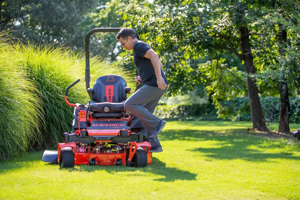 A person riding a riding lawn mower, finding tips on buying a riding lawn mower nearby