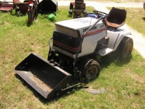 Lawn mower with front scoop