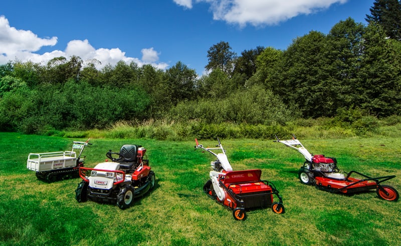 Rental riding brush mower gathered with other rental vehicles