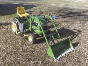 Mower with scoop attached in front of it