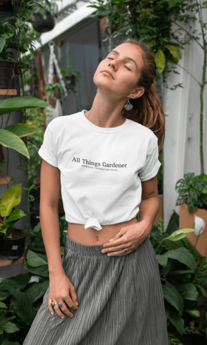 Mockup-of-a-young-woman-wearing-a-knotted-t-shirt-by-some-plants-27090